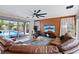 Inviting living room with views of the pool and backyard, featuring comfortable leather seating at 9710 Hiking Ave, Las Vegas, NV 89166