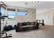 Bright living room featuring a comfortable couch and large windows with natural light at 9710 Hiking Ave, Las Vegas, NV 89166