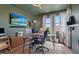 Bright office space featuring multiple monitors, a comfortable chair, and natural light from large windows at 9710 Hiking Ave, Las Vegas, NV 89166