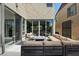 Relaxing patio space with a cozy seating area and modern fire pit with neighborhood view at 9710 Hiking Ave, Las Vegas, NV 89166