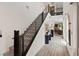 Modern staircase with metal railings leading to an upper level, providing a clear view of the open living space at 9710 Hiking Ave, Las Vegas, NV 89166