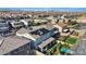 Real estate image showcasing an aerial view of a home with solar panels, a backyard and lush landscaping at 10057 Matter Overlook Dr, Las Vegas, NV 89178