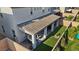 Aerial view of a backyard showcasing a covered patio, hot tub, artificial grass, and inviting outdoor spaces at 10057 Matter Overlook Dr, Las Vegas, NV 89178