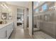 Well-lit bathroom featuring double sinks, shower with glass door, and easy access to the main bedroom at 10057 Matter Overlook Dr, Las Vegas, NV 89178