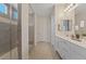 Modern bathroom features a glass shower, double vanity sinks, and herringbone tile flooring at 10057 Matter Overlook Dr, Las Vegas, NV 89178
