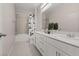 Bright bathroom featuring a double vanity, modern fixtures, and a shower-tub combination with a stylish shower curtain at 10057 Matter Overlook Dr, Las Vegas, NV 89178