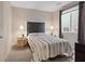 Well-lit bedroom featuring a comfortable bed, bedside tables, and a window offering natural light and city views at 10057 Matter Overlook Dr, Las Vegas, NV 89178