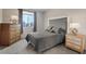 Neutral bedroom features a gray color scheme, dresser, two side tables, and ample light at 10057 Matter Overlook Dr, Las Vegas, NV 89178