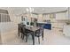 Open dining area features a table with seating for six, flowing into a modern kitchen with an island at 10057 Matter Overlook Dr, Las Vegas, NV 89178