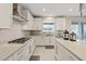 Contemporary kitchen with white cabinetry, expansive countertops, and stainless steel accents at 10057 Matter Overlook Dr, Las Vegas, NV 89178