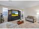 Comfortable living room with a media center, decorative rug, and natural light from nearby windows at 10057 Matter Overlook Dr, Las Vegas, NV 89178