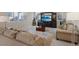 Inviting living room featuring a comfortable sofa, media center, and stylish rug for a cozy and relaxing atmosphere at 10057 Matter Overlook Dr, Las Vegas, NV 89178