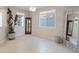 Bright living room featuring tiled floors, decorative accessories, and multiple windows at 10057 Matter Overlook Dr, Las Vegas, NV 89178