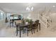 Inviting open living area and dining space with lots of natural light, access to a staircase, and comfortable seating at 10057 Matter Overlook Dr, Las Vegas, NV 89178