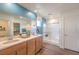 Bright bathroom featuring double vanity, large mirror, walk-in shower, and walk-in closet at 1013 Gentle Swan St # 696, Henderson, NV 89011