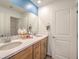 This bathroom includes a double vanity, lots of counterspace, and a large mirror at 1013 Gentle Swan St # 696, Henderson, NV 89011