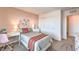 Cozy bedroom featuring a bed, desk, floral accents, carpet and closet at 1013 Gentle Swan St # 696, Henderson, NV 89011