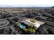 Overhead view displaying desert home, pool area, and covered parking at 10140 W Tropical Pkwy, Las Vegas, NV 89149