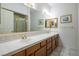 Bathroom featuring double sinks, neutral tiling, and a large mirror at 10140 W Tropical Pkwy, Las Vegas, NV 89149