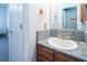 Bathroom with granite countertop, wood cabinet, and modern fixtures at 10140 W Tropical Pkwy, Las Vegas, NV 89149