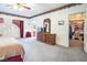 Spacious main bedroom features soft carpet, wood dresser, and walk-in closet at 10140 W Tropical Pkwy, Las Vegas, NV 89149