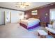 Spacious main bedroom featuring soft carpet, a ceiling fan, and comfortable seating at 10140 W Tropical Pkwy, Las Vegas, NV 89149
