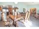 Dining room with a wooden table set and views of the adjacent kitchen and living spaces at 10140 W Tropical Pkwy, Las Vegas, NV 89149