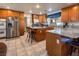 Spacious kitchen with stainless steel appliances, wood cabinets, and granite countertops at 10140 W Tropical Pkwy, Las Vegas, NV 89149