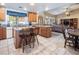Open-concept kitchen featuring granite countertops, stainless steel appliances, and eat-in island at 10140 W Tropical Pkwy, Las Vegas, NV 89149