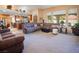 Bright living room featuring an oversized sectional sofa with large sunny windows at 10140 W Tropical Pkwy, Las Vegas, NV 89149