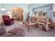 Cozy living room with traditional furnishings and lots of natural light from a large window at 10140 W Tropical Pkwy, Las Vegas, NV 89149