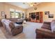 Comfortable living room with a media center and lots of natural light from the large windows at 10140 W Tropical Pkwy, Las Vegas, NV 89149