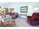 Living room connecting to the dining area, featuring cozy seating and ample natural light at 10140 W Tropical Pkwy, Las Vegas, NV 89149