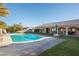 A sparkling pool with a slide and lush lawn is perfect for outdoor relaxation at 10140 W Tropical Pkwy, Las Vegas, NV 89149