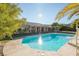 Enjoy this backyard oasis featuring a pool with slide and lounge area at 10140 W Tropical Pkwy, Las Vegas, NV 89149