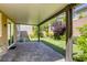 Covered back patio features brick floor, artificial turf and lush landscaping at 10164 Phelps Lake Ct, Las Vegas, NV 89148