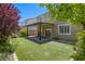 The backyard features a covered patio, green artificial turf, and meticulous landscaping at 10164 Phelps Lake Ct, Las Vegas, NV 89148