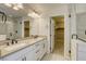 Modern bathroom featuring double vanity, large mirror and glass shower door at 10164 Phelps Lake Ct, Las Vegas, NV 89148