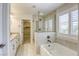 Modern bathroom featuring double vanity, a separate shower and tub and natural light at 10164 Phelps Lake Ct, Las Vegas, NV 89148