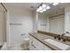 Bright bathroom featuring a vanity with modern faucet and a shower with curtain at 10164 Phelps Lake Ct, Las Vegas, NV 89148