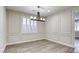 Bright dining room with paneled walls, wooden floors, and modern chandelier at 10164 Phelps Lake Ct, Las Vegas, NV 89148