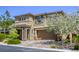 Two story home with neutral colored stucco, stone facade, and attached two car garage at 10164 Phelps Lake Ct, Las Vegas, NV 89148