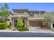 Two-story home boasts a stone facade, covered porch, and well-manicured landscaping at 10164 Phelps Lake Ct, Las Vegas, NV 89148