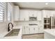An elegant kitchen featuring a deep sink, modern fixtures, and stainless steel appliances at 10164 Phelps Lake Ct, Las Vegas, NV 89148