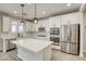This kitchen offers a central island, stainless appliances, and stylish pendant lighting at 10164 Phelps Lake Ct, Las Vegas, NV 89148