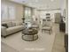 Open-concept living area flowing to the kitchen, with modern furnishings and natural light at 10164 Phelps Lake Ct, Las Vegas, NV 89148