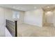 Bright loft space featuring neutral walls, carpet, a dark wood banister and natural light from the window at 10164 Phelps Lake Ct, Las Vegas, NV 89148