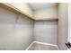 Bright walk-in closet featuring neutral carpeting and ample shelving for storage at 10164 Phelps Lake Ct, Las Vegas, NV 89148