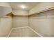 Spacious walk-in closet featuring neutral carpeting and ample shelving for storage at 10164 Phelps Lake Ct, Las Vegas, NV 89148