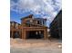 New two-story home under construction featuring a spacious garage and modern architectural design with blue sky at 10315 Water Knot Ave, Las Vegas, NV 89166